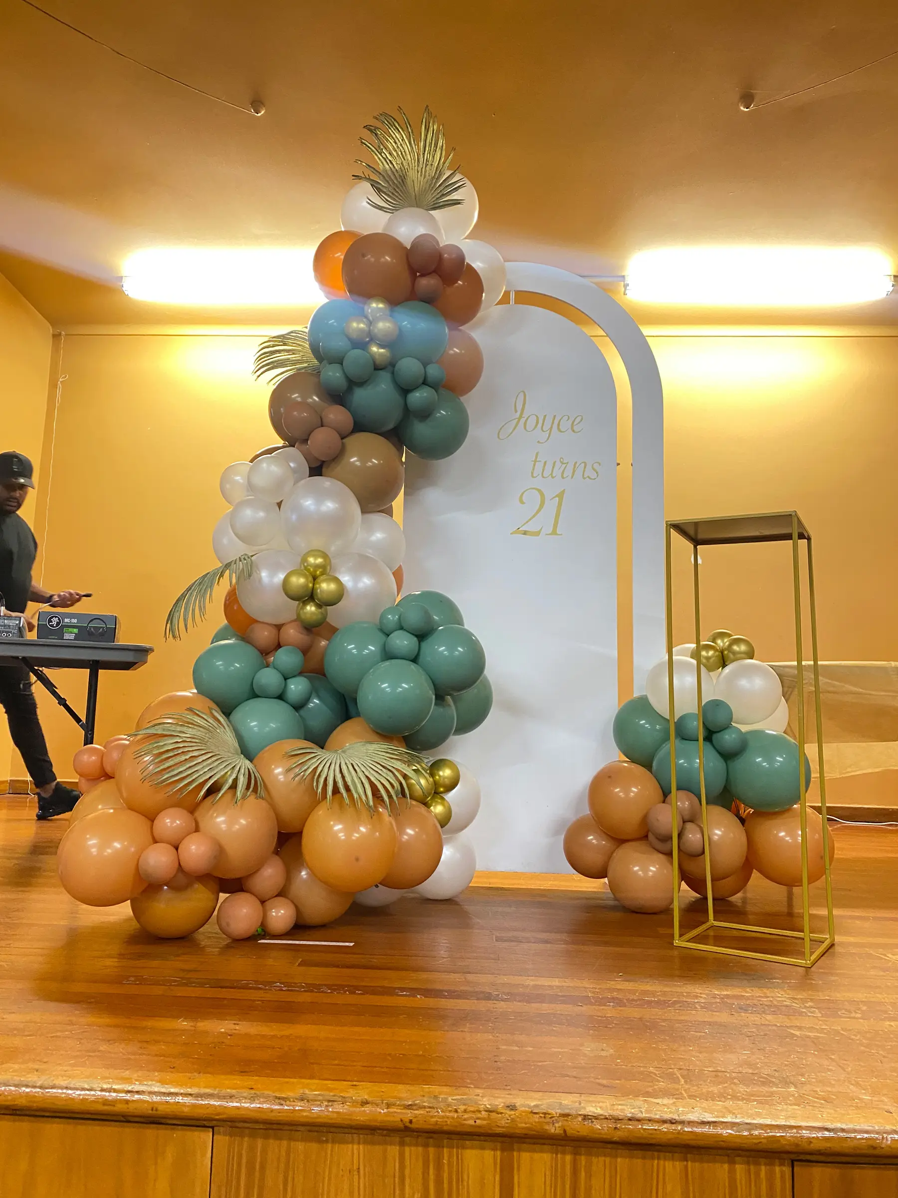 Birthday styling by Decoration X: Teal/gold balloon arch, '21' board, hall.