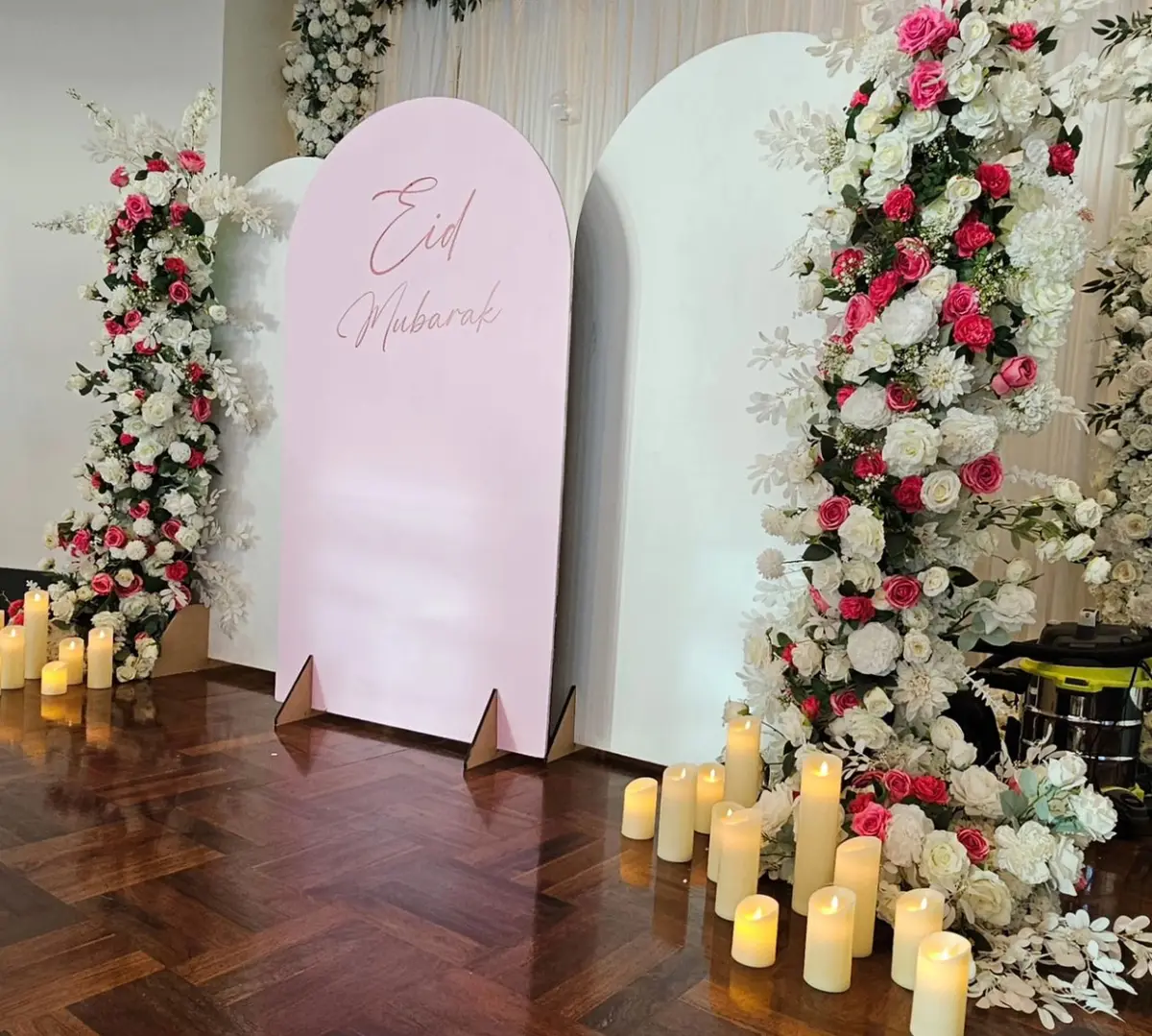 Cultural styling by Decoration X: 'Eid Mubarak' pink arch board with florals and candles.