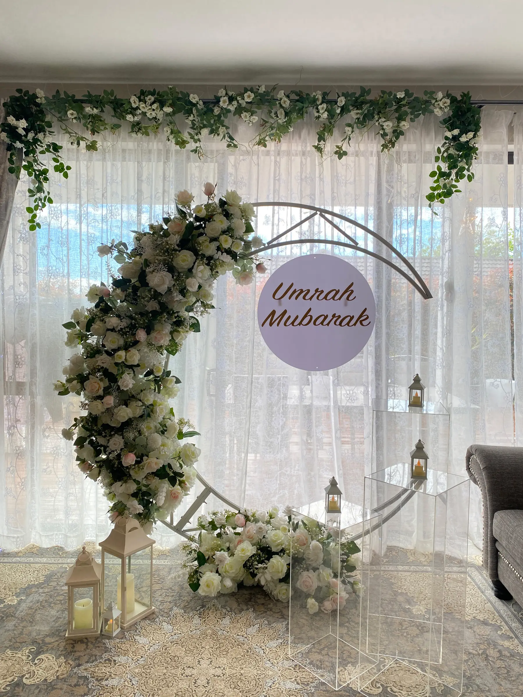 Cultural styling by Decoration X: 'Umrah Mubarak' white moon arch, drapes, candles.