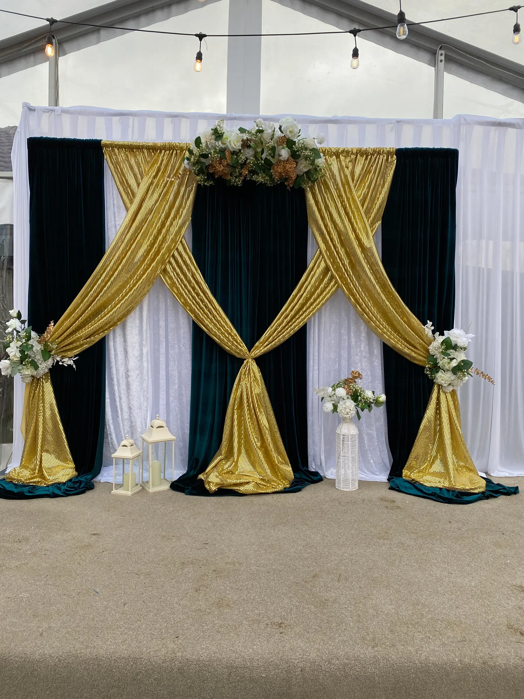 Reception styling by Decoration X: Emerald velvet and gold sequin crossed drapes, lanterns; marquee.